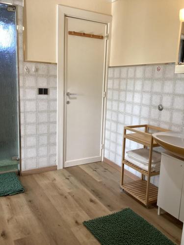 a bathroom with a white door and a sink at "Au repos de la citadelle" , 2 Adultes Max , et 2 Enfants Max in Namur