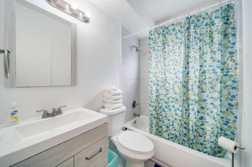 La salle de bains est pourvue de toilettes et d'un rideau de douche. dans l'établissement Beachy 1 b/r, w/2 Queen Beds, On Ocean Drive Beach, à Miami Beach