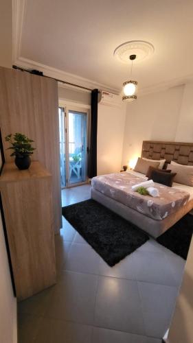 a bedroom with a large bed in a room at Appart Hotel Tanger Paname in Tangier