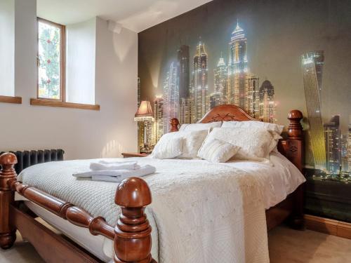 a bedroom with a large mural of a city at 4 Bed in Latchley 77480 in Sydenham Damerel