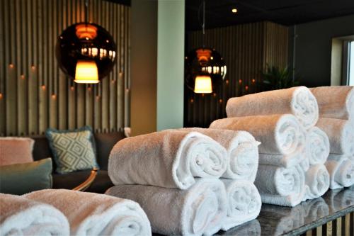 a pile of towels on a counter in a room at ProfilHotels Halmstad Plaza in Halmstad