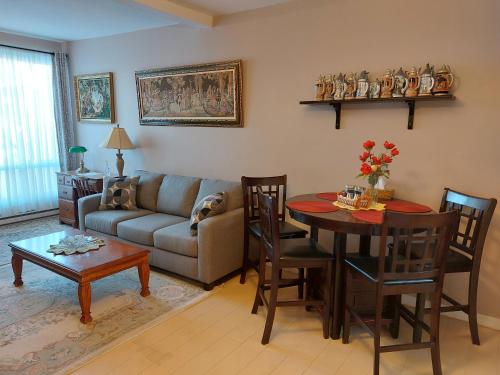 a living room with a couch and a table at Appartement Cartier2 Free parking Backyard in Longueuil