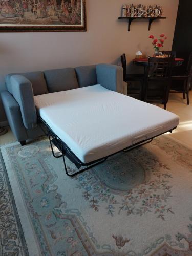 a mattress on a bed in a room with a couch at Appartement Cartier2 Free parking Backyard in Longueuil