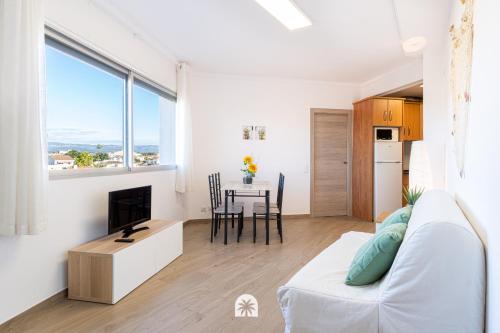 ein Wohnzimmer mit einem weißen Sofa und einem Tisch in der Unterkunft Mediterranean Way - Panoramic in Cambrils