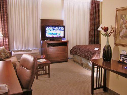 a hotel room with a bed and a television at Staybridge Suites Harrisburg-Hershey, an IHG Hotel in Harrisburg