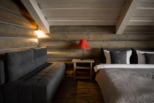 a bedroom with two beds and a couch and a lamp at Charlton Estate in Yablunytsya