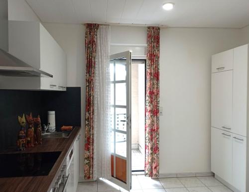 a kitchen with a sliding glass door to a patio at Monteurwohnung Renate in Saarbrücken