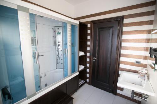 a bathroom with a shower and a sink at Hotel Victoria Tirana in Tirana