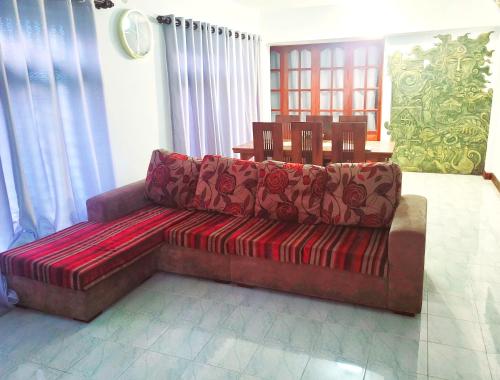 a living room with a couch and a table at Traveller's casa closer to highway in Homagama