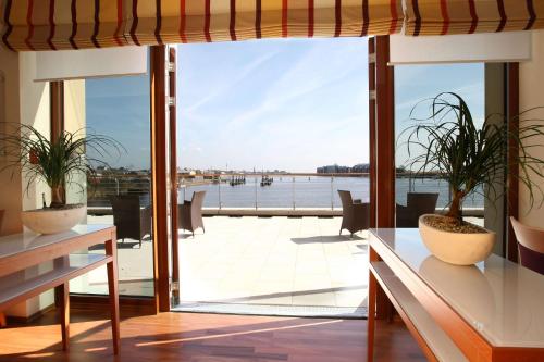 a house with a view of the water at ATLANTIC Hotel Wilhelmshaven in Wilhelmshaven