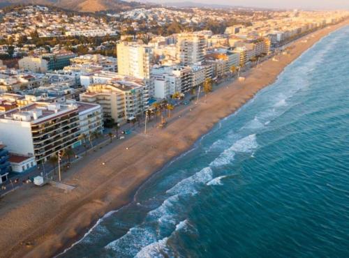 an aerial view of a beach with buildings and the ocean at Cozy Apartment 50 meters beach in Calafell