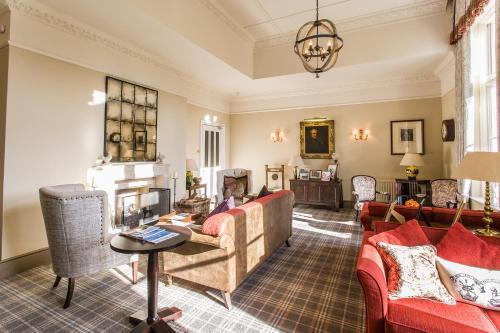 a living room with a couch and a fireplace at Langrish House in Petersfield