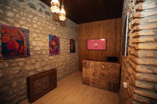 a room with paintings on the walls of a room at Art Hotel by ABAD Guest in Sheki