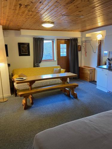 a living room with a table and a couch at Huddinge Studio with Private Entrance in Huddinge