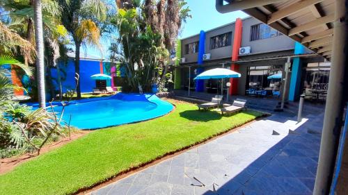 a resort with a swimming pool and a building at Elephant Springs in Bela-Bela