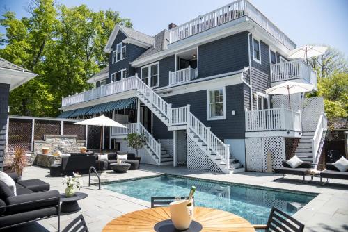 a house with a swimming pool in front of a house at Lindenwood Inn in Southwest Harbor