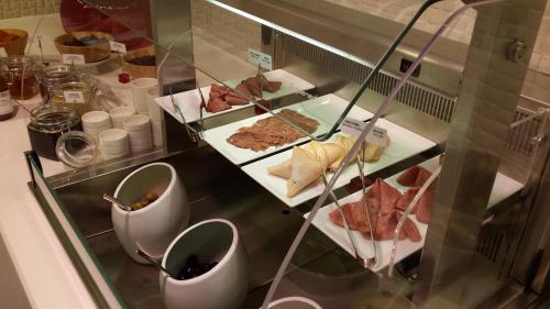a buffet with different types of food on plates at Warwick Ankara in Ankara