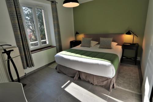a bedroom with a large bed in a room at Manoir de Montigny in Russy-Bémont