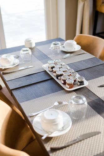 a table with a plate of cupcakes on it at Manoir de Montigny in Russy-Bémont