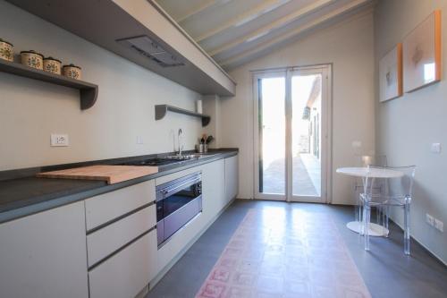 a kitchen with a sink and a stove at Resort Borgo Syrah in Cortona