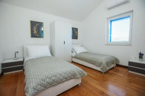 Postel nebo postele na pokoji v ubytování Apartments Seafront