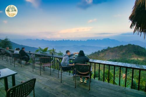 a couple sitting at a table looking out at the mountains at TVpalm Ecolodge in Ha Giang