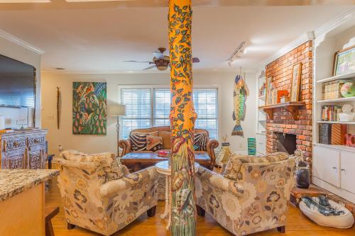 a living room with two chairs and a table at Creekside Paradise in Tybee Island