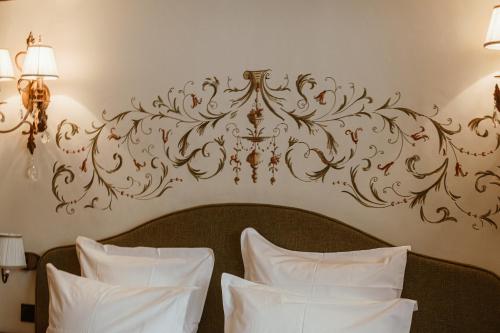 a bedroom with a bed with a chandelier on the wall at Hôtel de la Loze in Courchevel