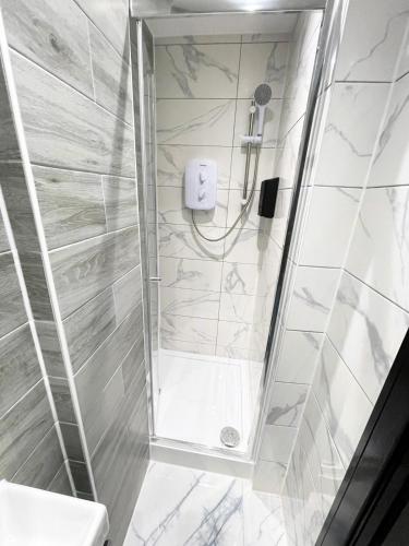 a bathroom with a shower and a toilet at Private Family and Business Rooms Harrow Fast WiFi in Pinner