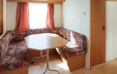 a living room with a couch and a table at 2 Bedroom Amazing Home In Mielno in Mielno