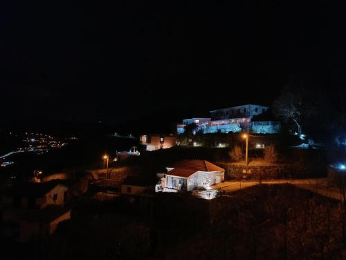 a night time view of a city with lights at Casa do Romezal in Peso da Régua