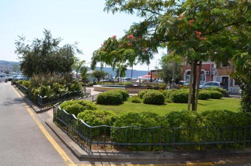 a park with bushes and trees on the side of a street at Villa Noa jacuzzi & sauna in Izola