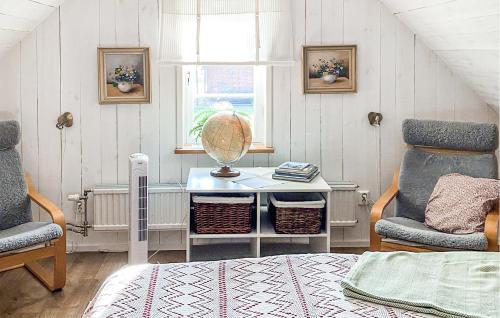 a room with a bed and a table and two chairs at Awesome Home In Visby With Kitchenette in Vall