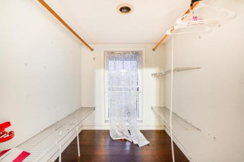 an empty room with a window and shelves at Pet-Friendly Syracuse Home with Private Yard! in Syracuse