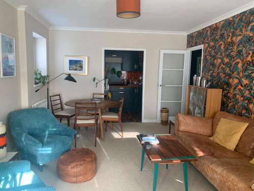 a living room with a couch and a table at Cosy room 10 min from beach in Brighton & Hove