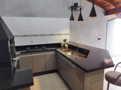 a kitchen with a sink and a counter top at Residencia Cidade Verde 1 Ourinhos in Ourinhos