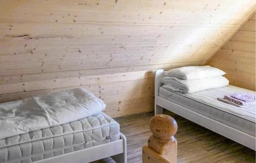 a room with two beds in a attic at Stunning Home In Chlopy With Wi-fi in Chłopy