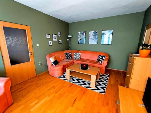 a living room with a couch and a table at Apartmán Green in Nitra