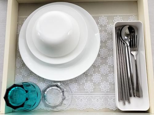 a white plate on a table with a fork and knife at Avanti house室見 in Fukuoka