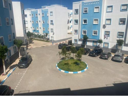 a large parking lot with cars parked in a parking lot at Luxury appartment Oumi in Martil