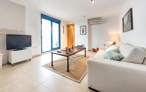 a living room with a white couch and a table at Awesome Apartment In Moncofa in Moncófar