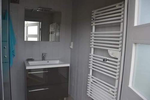 a bathroom with a sink and a towel rack at La bulle 