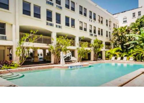 une grande piscine en face d'un bâtiment dans l'établissement Romantic Studio in the Heart of Palm Beach, à Palm Beach