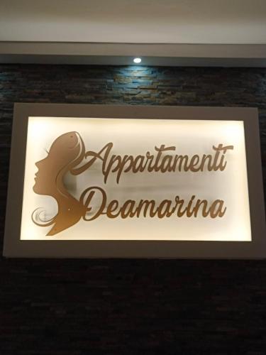 a sign for an apartment department decemberana on a wall at Residence Deamarina in Marina di Massa