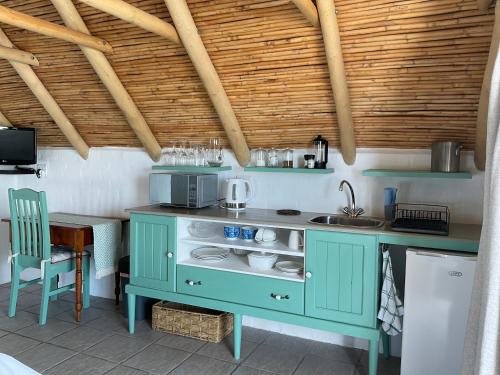 a kitchen with a blue cabinet and a sink at Nova Vida in Paternoster