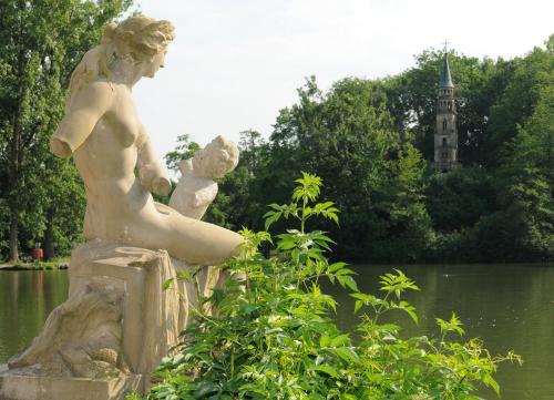 a statue of a woman sitting on a rock in a park at Schlosshotel Monrepos in Ludwigsburg