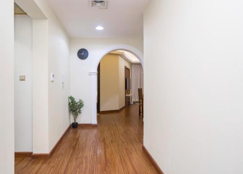 an arched hallway with white walls and wood floors at ZAPBED House - AWP 1501 in Dubai