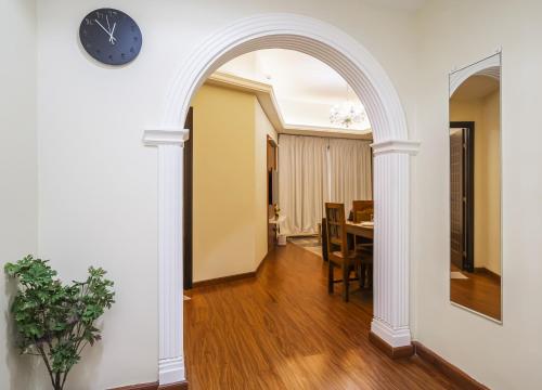 an archway in a living room with a table and a clock at ZAPBED House - AWP 1501 in Dubai