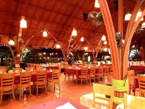 a restaurant with tables and chairs in a building at The Song Luxury Vung Tau Apartment - QUỲNH's Homestay in Vung Tau