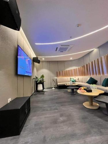 a conference room with tables and a tv in it at The Song Luxury Vung Tau Apartment - QUỲNH's Homestay in Vung Tau